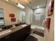 Modern bathroom with double vanity, shower, and bathtub at 331 Muirfield Loop, Reunion, FL 34747