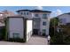 Modern three-story home with a two-car garage at 331 Muirfield Loop, Reunion, FL 34747
