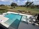 Large, refreshing pool with plenty of lounge chairs and a basketball hoop at 331 Muirfield Loop, Reunion, FL 34747