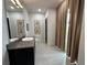 Stylish bathroom with granite vanity and large mirror at 331 Muirfield Loop, Reunion, FL 34747