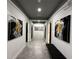 Modern hallway with gray tile floors and large abstract art pieces at 331 Muirfield Loop, Reunion, FL 34747
