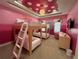 Fun bunk bed room with pink walls and playful decor at 331 Muirfield Loop, Reunion, FL 34747