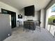 Covered outdoor kitchen with grill and bar seating at 331 Muirfield Loop, Reunion, FL 34747