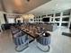 Elegant dining room with large table and crystal chandelier at 331 Muirfield Loop, Reunion, FL 34747