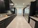 Modern kitchen with dark cabinetry and stainless steel appliances at 331 Muirfield Loop, Reunion, FL 34747