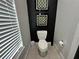Contemporary powder room with black accent wall and geometric art at 331 Muirfield Loop, Reunion, FL 34747