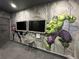 Game room featuring Hulk and Captain America murals and two large TVs at 331 Muirfield Loop, Reunion, FL 34747