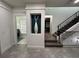 Stylish hallway featuring a contemporary staircase and decorative vase at 331 Muirfield Loop, Reunion, FL 34747
