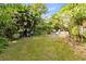 Large grassy backyard with tropical landscaping and a patio area at 180 N Lakewood Cir, Maitland, FL 32751