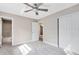 Bright bedroom with ceiling fan, carpet flooring, and large closet at 180 N Lakewood Cir, Maitland, FL 32751