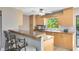 Bright kitchen with light wood cabinets and granite countertops at 180 N Lakewood Cir, Maitland, FL 32751