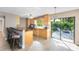 Bright kitchen with light wood cabinets, granite countertops, and view of backyard patio at 180 N Lakewood Cir, Maitland, FL 32751