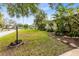 Landscaped side yard with tropical plants and stone path at 180 N Lakewood Cir, Maitland, FL 32751