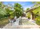 Spacious backyard patio with fire pit and lush tropical landscaping at 180 N Lakewood Cir, Maitland, FL 32751