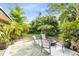 Relaxing backyard with fire pit, patio, and abundant tropical plants at 180 N Lakewood Cir, Maitland, FL 32751