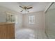 Bright bedroom with two windows and tile floors at 793 E Birchwood Cir, Kissimmee, FL 34743