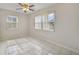 Spacious bedroom with two windows and tile flooring at 793 E Birchwood Cir, Kissimmee, FL 34743