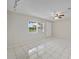 Living room with large window and tile flooring at 793 E Birchwood Cir, Kissimmee, FL 34743