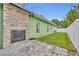 Landscaped backyard with a stone fireplace at 3136 Heartleaf Pl, Winter Park, FL 32792