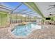 Freeform swimming pool with a screened enclosure at 3136 Heartleaf Pl, Winter Park, FL 32792
