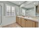 Bathroom with double sinks, large mirror, and a walk-in shower at 3136 Heartleaf Pl, Winter Park, FL 32792
