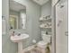Clean bathroom with pedestal sink, toilet, and a shower at 3136 Heartleaf Pl, Winter Park, FL 32792