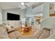 Relaxing living room with large TV and hardwood floors at 3136 Heartleaf Pl, Winter Park, FL 32792