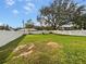 Large backyard with lush green grass and a white fence at 303 Carleton St, Lakeland, FL 33803