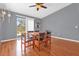 Dining area features hardwood floors, a wooden table, and sliding door access to the backyard at 911 Vassar Dr, Eustis, FL 32726