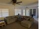 Relaxing living room with sectional sofa, ceiling fan, and lots of pillows at 1301 Redwood Ct, Tavares, FL 32778