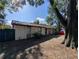 House exterior, front view, with large tree at 1301 Redwood Ct, Tavares, FL 32778
