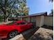 House exterior with red car parked in front at 1301 Redwood Ct, Tavares, FL 32778