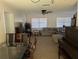 Dining area with glass-top table, six chairs, and a dark brown piano at 1301 Redwood Ct, Tavares, FL 32778