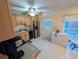 Kitchen with light wood cabinets, stainless steel appliances, and backyard access at 1301 Redwood Ct, Tavares, FL 32778
