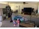 Gathering-friendly living room with sectional sofa, TV, and toys at 1301 Redwood Ct, Tavares, FL 32778