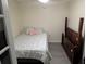 Cozy bedroom with a double bed and wood frame at 1301 Redwood Ct, Tavares, FL 32778