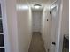 Clean and spacious hallway with neutral-colored walls and carpet at 1301 Redwood Ct, Tavares, FL 32778