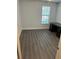 Bedroom with gray vinyl flooring and a window with blinds at 4647 Cason Cove Dr # 2425, Orlando, FL 32811