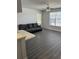 Living room with gray sofa and gray vinyl flooring at 4647 Cason Cove Dr # 2425, Orlando, FL 32811