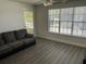 Living room featuring gray vinyl flooring and a large window at 4647 Cason Cove Dr # 2425, Orlando, FL 32811