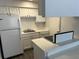 White kitchen with white appliances and cabinets at 4647 Cason Cove Dr # 2425, Orlando, FL 32811