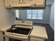 Kitchen with white appliances and a view of the living room at 4647 Cason Cove Dr # 2425, Orlando, FL 32811
