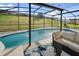 Relaxing pool area with screened enclosure, patio furniture, and water features at 6844 Pomeroy Cir, Orlando, FL 32810