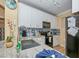 Modern kitchen with white cabinets, granite counters, and a black refrigerator at 912 Charo Pkwy # 223, Davenport, FL 33897