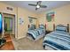 Guest bedroom with two twin beds and coastal-themed bedding at 912 Charo Pkwy # 223, Davenport, FL 33897