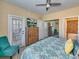 King bed, dresser, teal chair, and private balcony access at 912 Charo Pkwy # 223, Davenport, FL 33897