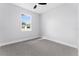 Cozy bedroom with grey carpet and a window at 405 N Mcdonald Ave, Deland, FL 32724