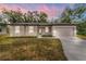 One-story home with a two-car garage and landscaped front yard at 405 N Mcdonald Ave, Deland, FL 32724