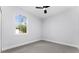 Bright bedroom with window and ceiling fan at 405 N Mcdonald Ave, Deland, FL 32724