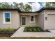 Tan house with black trim, walkway, and landscaping at 405 N Mcdonald Ave, Deland, FL 32724